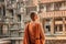 Closeup view of Buddhist monk looking at courtyard of Angkor Wat