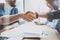 Closeup view of Business male partnership handshake. Photo two coworkers handshaking process. Successful deal after great