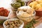 Closeup view of charcuterie board with assortment of antipasti served on wooden plate