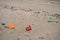Closeup view of colorful children plastic toys left or forgotten at Sandymount Beach after messy sea activities during lowest tide