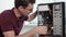 Closeup view of a concentrated computer service worker in glasses fixing a broken computer in the office and upgrading