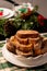 Closeup view of delicious french toast stack on a white plate on a Christmas style decorated table