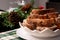 Closeup view of delicious french toast stack on a white plate on a Christmas style decorated table