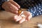 Closeup view female holding bottle pouring pills into palm