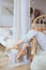 Closeup view of female legs and feet in a morning. Girl resting on the chair in cozy soft comfortable pajamas