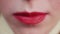 Closeup view of female mouth chewing gum. Woman with red lips and bad manners