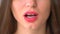 Closeup view of female mouth chewing gum. Woman with red lips and bad manners