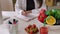 Closeup view of female nutritionist hands working on diet plan at consultation