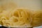 Closeup view of fettuccine pasta into boiling water in a saucepan