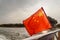 Closeup view of the flag of China fluttering at sunset