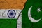 A closeup view of the flag of India and the flag of Pakistan against a background of cracked earth. The concept of the crisis of w