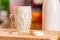 Closeup view fresh kefir probiotik drink emerged from overfilled empty glass on kitchen table