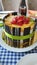 A closeup view of a fruit cake with strawberries and kiwi on top
