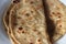 Closeup view of hand made plain bread in oil called paratha roti