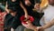 Closeup view of happy family of four sitting by the Christmas tree and eating chocolate cookies. Cute mother, father and