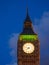 Closeup view of the illuminated Big Ben clock of the Elizabeth tower in London at night.