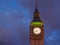 Closeup view of the illuminated Big Ben clock of the Elizabeth tower in London at night.