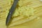 Closeup view of knife and ginger in cutting board background