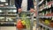 Closeup view of male consumer moving cart with fresh fruits and walking in store spbd.