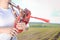 Closeup view of man enjoying playing pipes in traditional style. Green outdoors summer field background