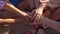 Closeup view of many hands together united in support. Teamwork and friendship concept. Slowmotion shot