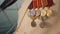 Closeup view of medal on jacket of male captain standing on boat outdoors.