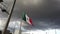 Closeup view of the national flag of Mexico shot from a highway on a cloudy day