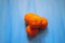 Closeup view of orange ripe clementine on blue background