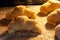 A closeup view of oven-baked bagels from a curd dough, sugar-frosted, lying on a baking sheet covered with parchment paper