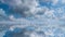 Closeup view of part of wing of flying above soft white fluffy clouds airplane as seen by passenger through porthole.