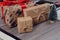 Closeup view photo of beautiful cute nice presents wrapped in old paper packed in red ribbon stand on green with snow