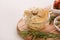 Closeup view of pickled artichokes served with rosemary on wooden board