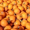 Closeup view on a pile of little orange pumpkins at a farmers market