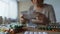 Closeup view of pills on table and old woman taking medicine behind, consumerism