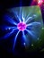 Closeup view of plasma globe lamp with electric rays.