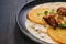 Closeup view of potato fritters with teriyaki chicken