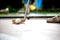 Closeup view from a professional minigolf player hitting a white