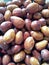 A closeup view of a quantity of jujubes fruits at a rional market stall