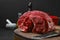 Closeup view of raw beef neck on wooden stump