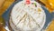 Closeup view of round white birthday cake with figures candles