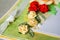 Closeup view of a scrapbooking card with paper flowers, ribbons and hand stitching