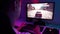 Closeup view from shoulder of unrecognizable male gamer driving race video game on pc computer in dark room. Close-up of