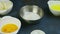 Closeup view on small metal bowl with sugar standing next to many white bowls