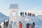 Closeup View of a Snow-covered Bell Tower - Hikers on a snowy mountain peak