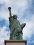 Closeup view of Statue of Liberty replica sculpture on Ile aux Cygnes at Pont de Grenelle Seine river Paris France