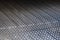 Closeup view stock photography of texture of black protective hdpe rug or mat for boot of automobile