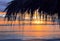 Closeup view of straw umbrella at sunset,paradise tropical beach,no people,amazing sea view,holiday,ocean background,bright sky