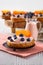 Closeup view of sweet buns with yogurt, blueberry and slice of persimmon on wooden table