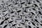 Closeup View of Used Dirty Greasy Oiled Bicycle Chain As A Part of Metal Bicycle Equipment On Stony Background With Contrast