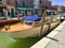 A closeup view of a Venice water taxi docked along a canal in Murano, Italy.